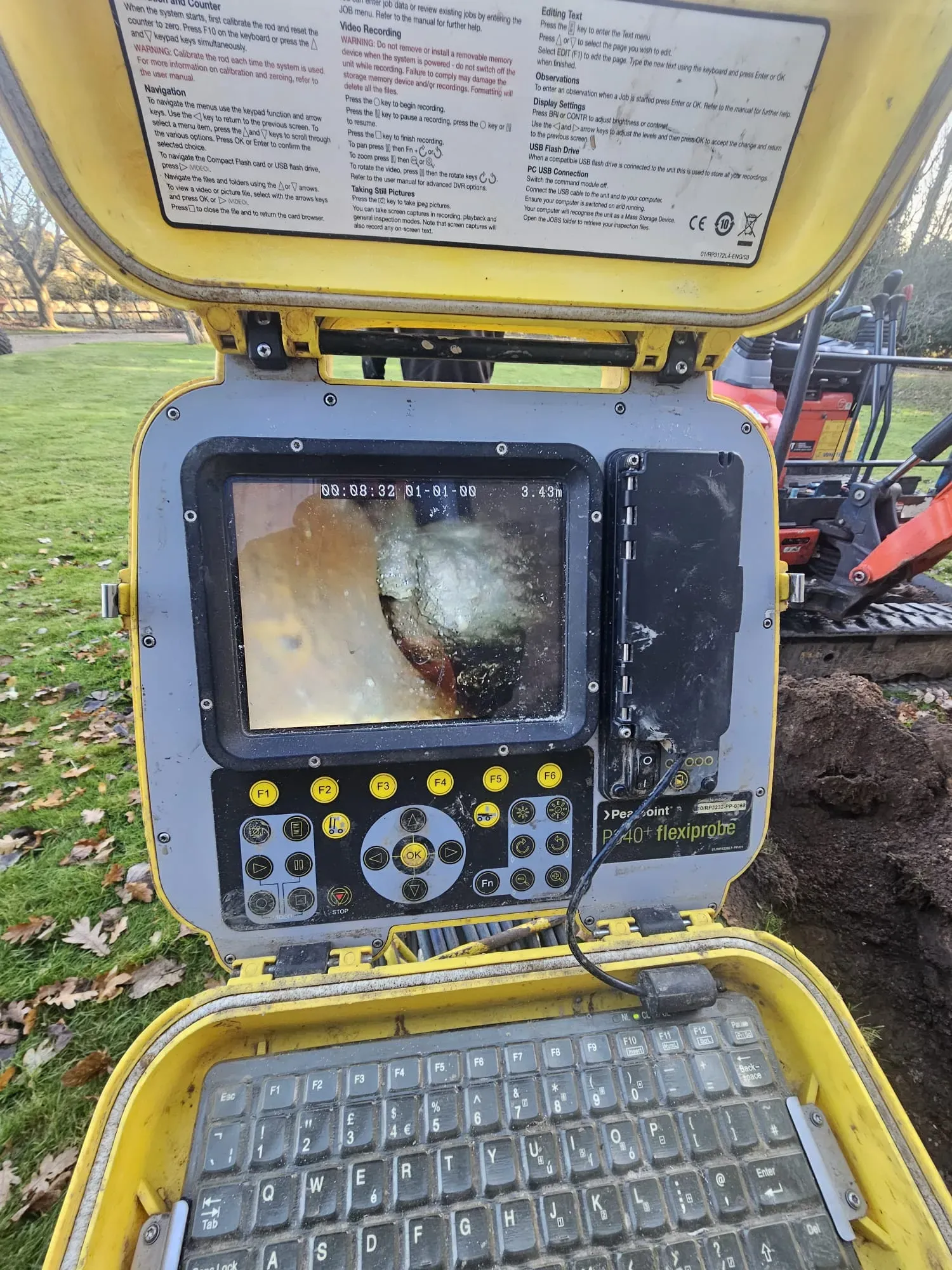 CCTV drain survey unit showing a blocked drain on its screen, used for inspecting pipes and diagnosing issues.