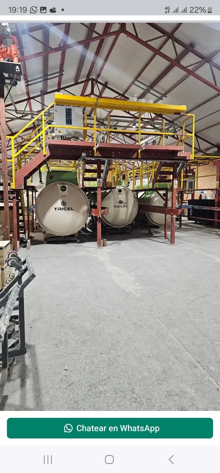 Tricel branded sewage treatment plant units inside a warehouse, representing off-mains drainage solutions offered by Eco Drain Solutions Ltd.